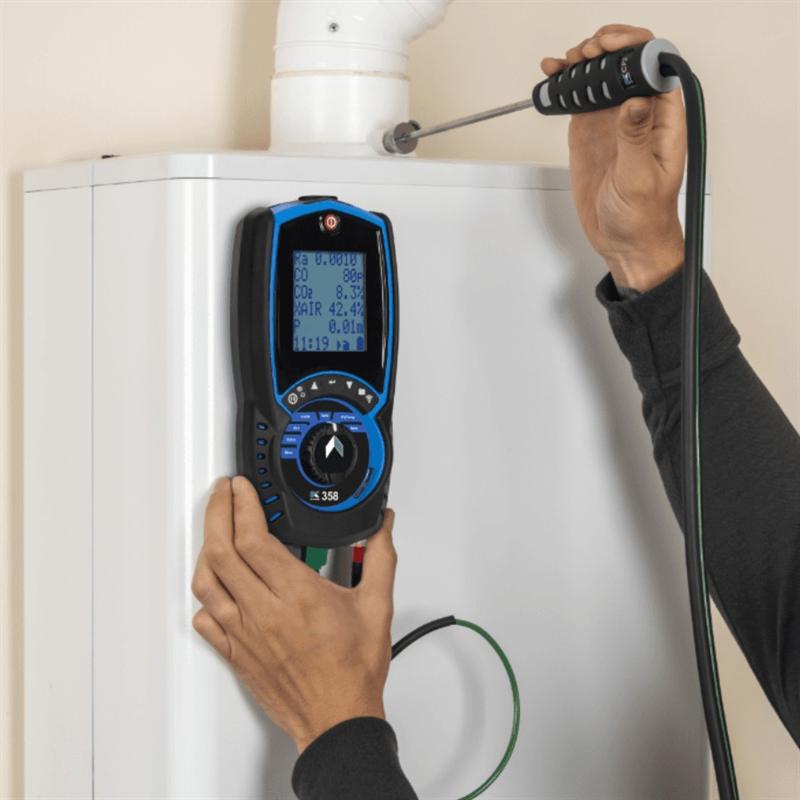 Gas Safe engineer taking a flue gas reading from a boiler with an electronic analyser